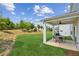 Spacious backyard featuring a well-maintained lawn and covered patio, ideal for outdoor living at 515 Cobblestone Ct, Canton, GA 30115