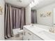 A well-lit bathroom features double sinks, a large mirror, and a shower with a stylish curtain at 515 Cobblestone Ct, Canton, GA 30115