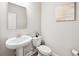 Stylish half-bathroom featuring a modern vanity, toilet, and decorative artwork that adds an elegant touch at 515 Cobblestone Ct, Canton, GA 30115