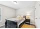 Cozy bedroom showcasing a single bed with yellow accents, a bedside table, and neutral walls at 515 Cobblestone Ct, Canton, GA 30115