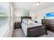 A primary bedroom features a large window, a queen sized bed, and dark wood furniture at 515 Cobblestone Ct, Canton, GA 30115