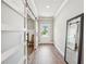 Elegant entryway featuring wood floors, modern sliding doors, and a clear view to the front door at 515 Cobblestone Ct, Canton, GA 30115