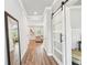 Bright entryway with wood floors, a large mirror, and sliding barn doors leading to other rooms in the house at 515 Cobblestone Ct, Canton, GA 30115