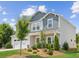 A charming two-story home featuring manicured landscaping and a blend of gray and white tones under a bright sky at 515 Cobblestone Ct, Canton, GA 30115