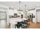 Bright open kitchen with white cabinets, stainless steel appliances, quartz countertops, and wood floors at 515 Cobblestone Ct, Canton, GA 30115