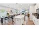 Bright open kitchen with an island, stainless steel appliances, wood floors, and a dining area at 515 Cobblestone Ct, Canton, GA 30115