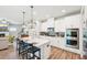 Spacious kitchen featuring a large island, stainless steel appliances, white cabinetry, and an open layout at 515 Cobblestone Ct, Canton, GA 30115