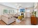 Bright living room with a cozy fireplace, plush seating, and lots of natural light from the many windows at 515 Cobblestone Ct, Canton, GA 30115