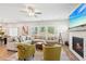 Comfortable living room featuring a fireplace, plush sectional, and floor-to-ceiling windows with scenic backyard views at 515 Cobblestone Ct, Canton, GA 30115