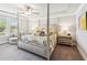 Serene main bedroom features a four poster bed, sitting area, and plenty of natural light at 515 Cobblestone Ct, Canton, GA 30115