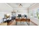 Well-lit home office with a large desk, modern decor, and ample natural light from the window at 515 Cobblestone Ct, Canton, GA 30115