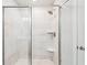 Modern shower featuring glass door, tiled walls, a built-in bench, and a rainfall shower head at 515 Cobblestone Ct, Canton, GA 30115
