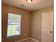 Cozy bedroom with neutral walls, a window, and a white door at 7400 Little Fawn Pkwy, Palmetto, GA 30268
