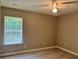 Bedroom with neutral walls, wood-look floors, ceiling fan and window with natural light at 7400 Little Fawn Pkwy, Palmetto, GA 30268