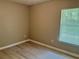 Bedroom with neutral walls, wood-look floors, ceiling fan and window with natural light at 7400 Little Fawn Pkwy, Palmetto, GA 30268