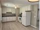 Functional kitchen featuring white appliances, ample cabinetry, and modern flooring at 7400 Little Fawn Pkwy, Palmetto, GA 30268
