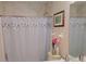 Cozy bathroom featuring a shower with leaf-patterned curtain and decorative artwork at 2905 Olde Town Park Dr, Norcross, GA 30071