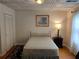 Cozy bedroom featuring tin ceiling, hardwood floors, and natural light at 2905 Olde Town Park Dr, Norcross, GA 30071
