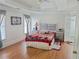 Cozy bedroom with tray ceilings, hardwood floors, a comfortable bed, and natural light creating a relaxing retreat at 2905 Olde Town Park Dr, Norcross, GA 30071
