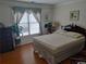 Bright bedroom with hardwood floors, large window, and comfortable furnishings at 2905 Olde Town Park Dr, Norcross, GA 30071