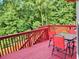 Large deck with a table, seating and treed view at 2905 Olde Town Park Dr, Norcross, GA 30071