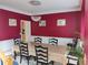 A formal dining room features red walls, white trim, a decorative chandelier, and seating for six at 2905 Olde Town Park Dr, Norcross, GA 30071