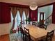 Formal dining room with decorative chandelier, large table, and access to staircase at 2905 Olde Town Park Dr, Norcross, GA 30071