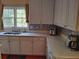 Bright kitchen featuring white cabinets, stone countertops, stainless steel sink, and a mosaic backsplash at 2905 Olde Town Park Dr, Norcross, GA 30071