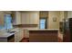 Well-lit kitchen with white cabinets, modern countertops, and built-in appliances at 2905 Olde Town Park Dr, Norcross, GA 30071