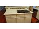 Kitchen island with gas cooktop, white cabinetry, and modern countertop at 2905 Olde Town Park Dr, Norcross, GA 30071
