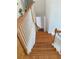 An interior staircase features hardwood steps, white risers, and wood banisters providing an elegant transition between levels at 2905 Olde Town Park Dr, Norcross, GA 30071