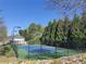 Community tennis court surrounded by trees and professional lighting at 2905 Olde Town Park Dr, Norcross, GA 30071