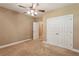 Neutral bedroom features carpet, ceiling fan, and closet, offering ample storage at 2969 Rivergreen Se Ln # 23, Atlanta, GA 30339
