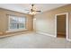 Bright bedroom with neutral walls and carpet, featuring a window and access to a closet at 2969 Rivergreen Se Ln # 23, Atlanta, GA 30339