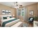 Stylishly furnished bedroom with a plush bed, scenic artwork, and accent chair at 2969 Rivergreen Se Ln # 23, Atlanta, GA 30339