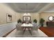 Elegant dining room with modern chandelier, wainscoting, and seating for six at 2969 Rivergreen Se Ln # 23, Atlanta, GA 30339