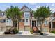 Brick townhome featuring an attached garage, manicured lawn, and well-maintained landscaping at 2969 Rivergreen Se Ln # 23, Atlanta, GA 30339