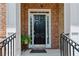 Beautiful brick home featuring a black front door framed by white columns at 2969 Rivergreen Se Ln # 23, Atlanta, GA 30339