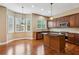 Kitchen with wooden cabinets, stainless steel appliances, and hardwood floors at 2969 Rivergreen Se Ln # 23, Atlanta, GA 30339