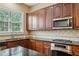 Kitchen features stainless steel appliances, dark countertops, and wood cabinets at 2969 Rivergreen Se Ln # 23, Atlanta, GA 30339