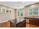 Stylish kitchen with dark granite island and counters, stainless steel appliances, and cozy breakfast nook at 2969 Rivergreen Se Ln # 23, Atlanta, GA 30339