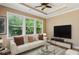 Comfortable living room with large windows providing backyard views, a ceiling fan and nice furniture at 2969 Rivergreen Se Ln # 23, Atlanta, GA 30339