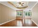 Spacious main bedroom with tray ceiling, ceiling fan, and many windows for natural light at 2969 Rivergreen Se Ln # 23, Atlanta, GA 30339