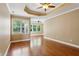 Empty main bedroom with tray ceiling, ceiling fan, and many windows for natural light at 2969 Rivergreen Se Ln # 23, Atlanta, GA 30339