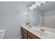 Bright bathroom featuring double sinks, a large mirror, and a bathtub with shower at 3014 Liberty Nw Way, Atlanta, GA 30318
