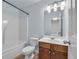 Bathroom featuring a shower and tub combo, neutral walls, and modern light fixtures at 3014 Liberty Nw Way, Atlanta, GA 30318