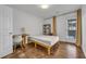 Bright bedroom showcasing wood floors, a workspace, and convenient access to a private outdoor patio at 3014 Liberty Nw Way, Atlanta, GA 30318