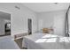 Spacious bedroom with neutral walls and natural light, adjacent to a seating area and ensuite bathroom at 3014 Liberty Nw Way, Atlanta, GA 30318