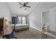 Cozy bedroom with ceiling fan, a desk and chair, a view to a private bathroom, and carpeted floor at 3014 Liberty Nw Way, Atlanta, GA 30318