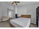 Carpeted bedroom with a bed, chair, bookshelf, and a calming neutral color scheme at 3014 Liberty Nw Way, Atlanta, GA 30318